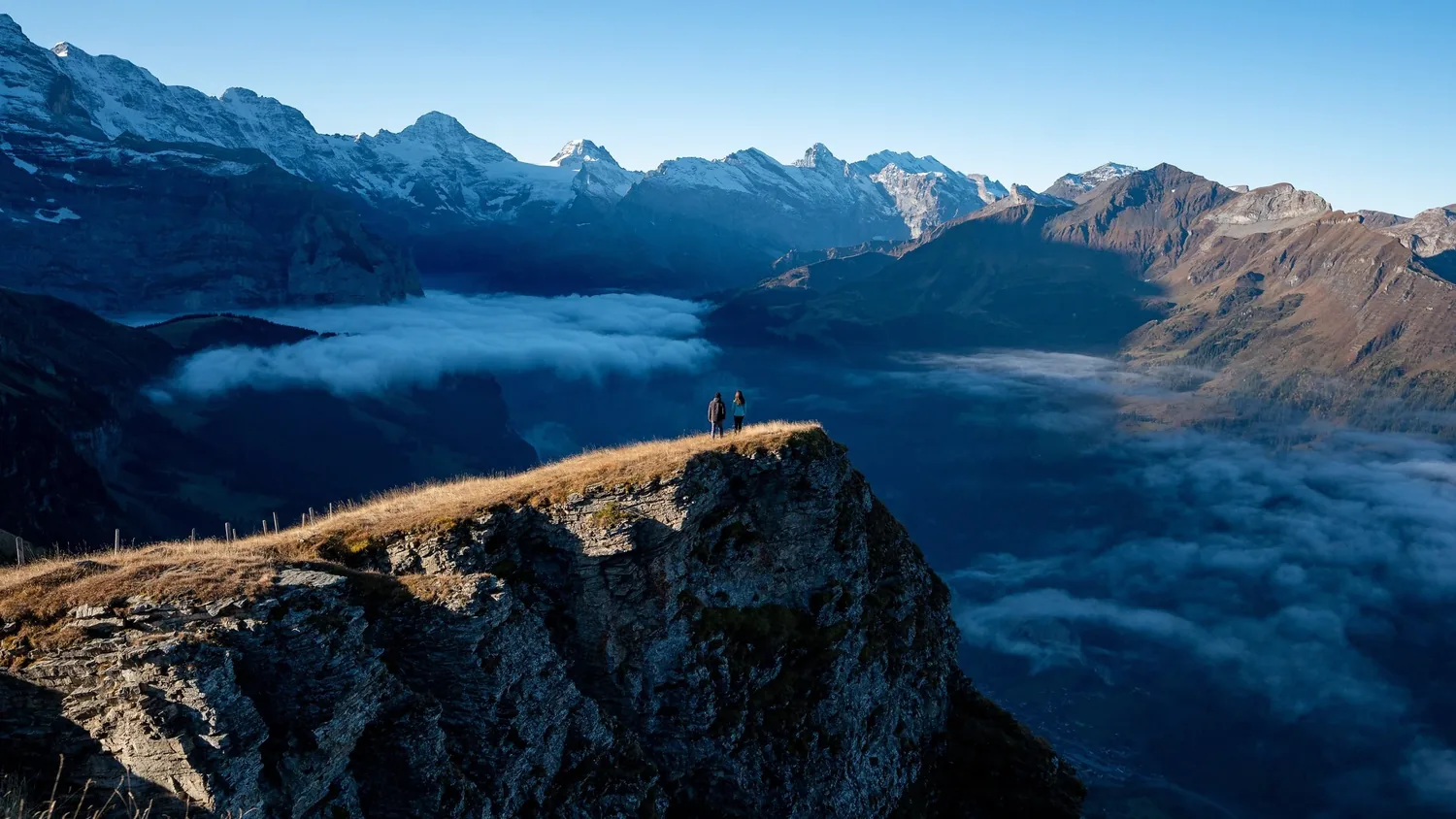 Alex and Vanessa looking out over the clouds from an Alpine ridge